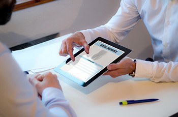 A dental insurance agent showing an insurance form to a patient