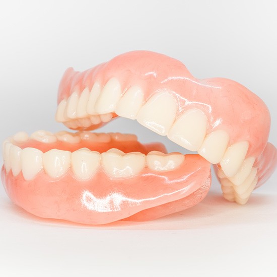 Two full dentures in Arvada, CA with one sitting on top