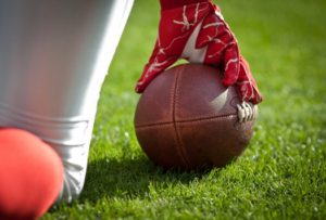 Close up of football player setting up the ball